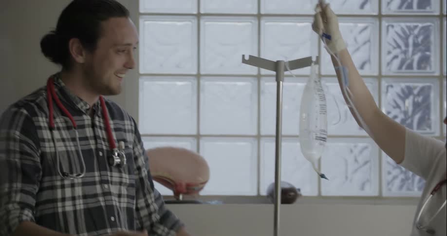 A nurse attaches an iv line while chatting