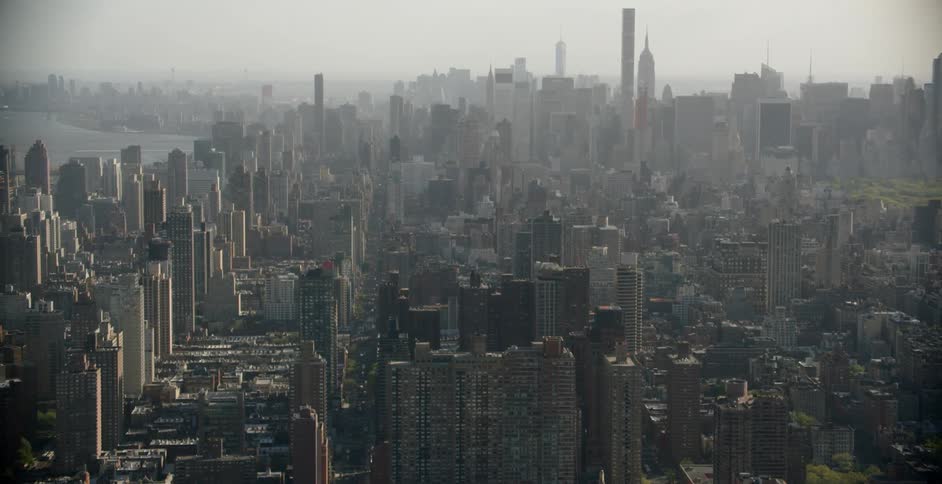 The large city is covered with fog
