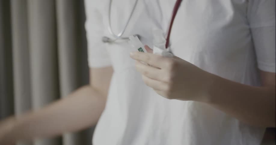 A doctor preparing a syringe