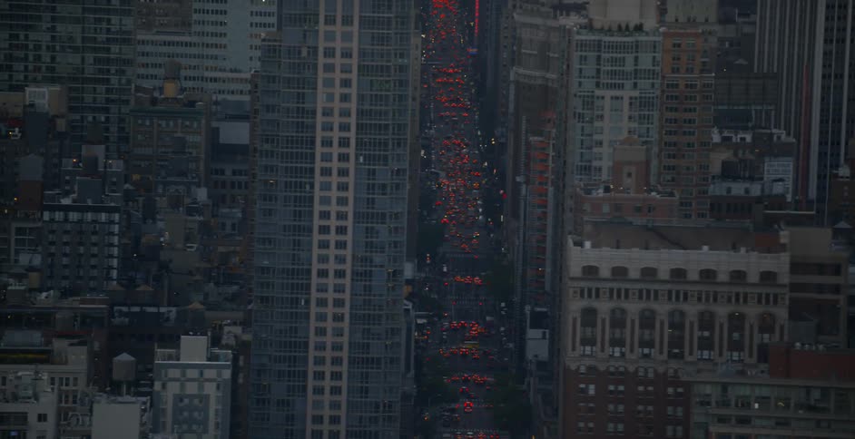 Many buildings line this city at sunset