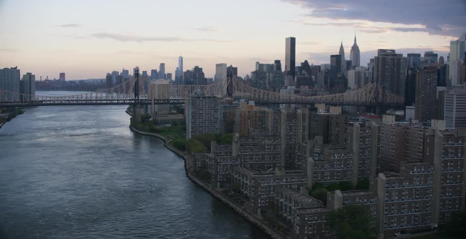 A bridge leads to the city at sunset