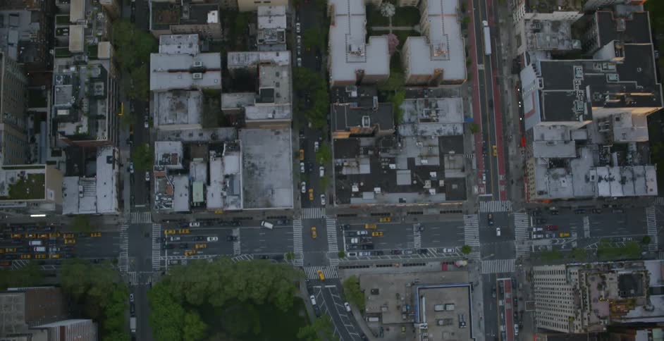 Cars slowly travel down the streets of this city below