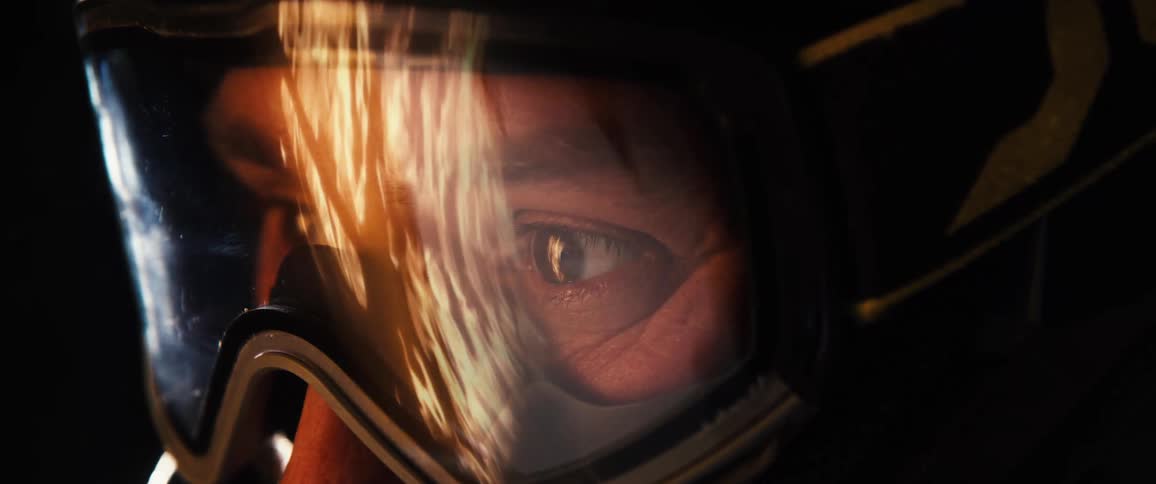 Man in helmet watching with a reflection of fire flames