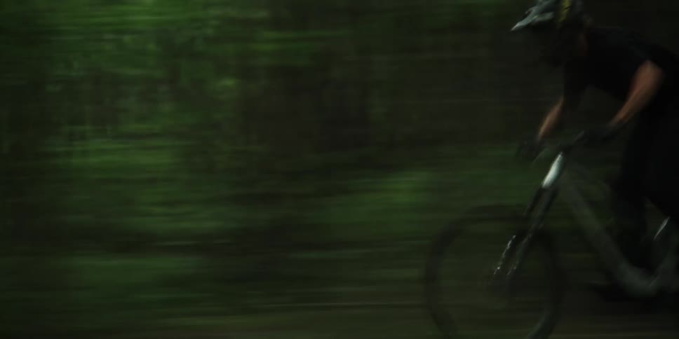 Man riding a mountain bike on a forest trail