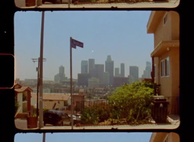 A road goes past the homes towards the city