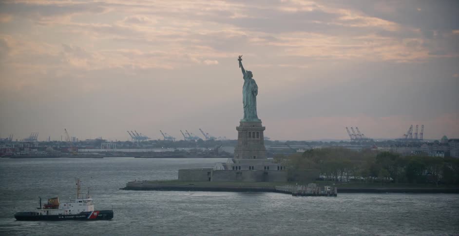 The statue of liberty towers above the water