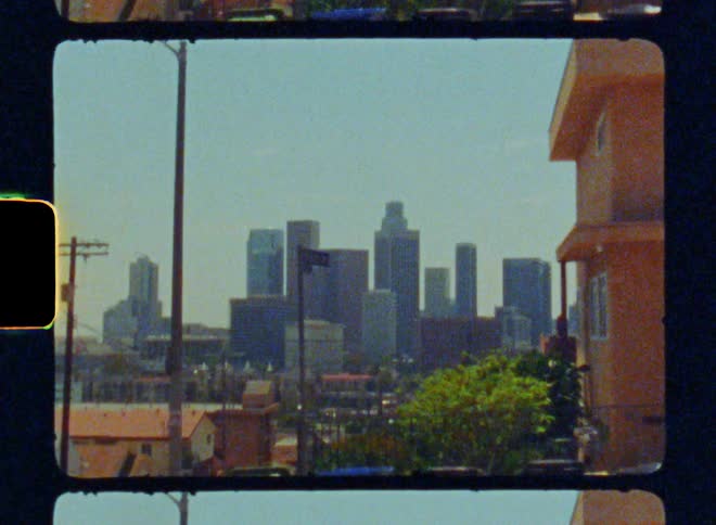 A row of very tall buildings is past the homes