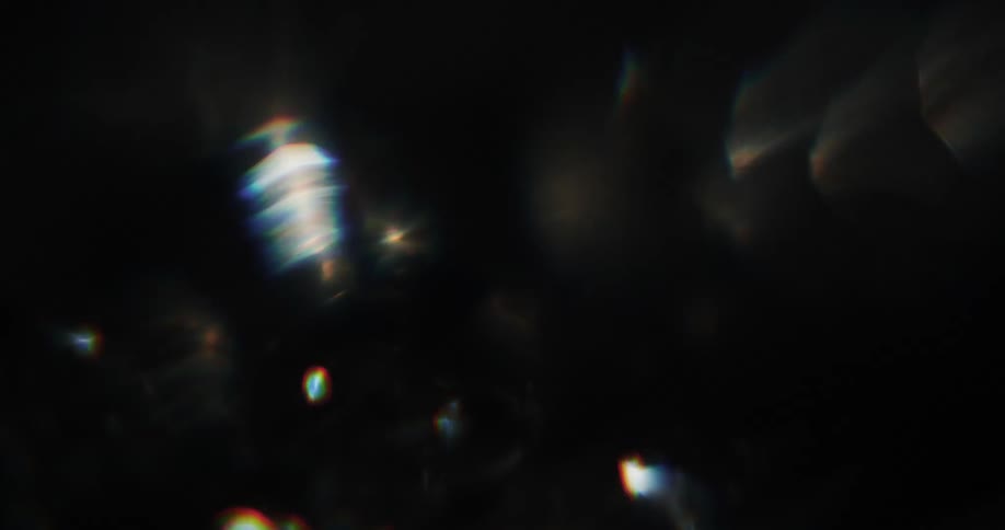 Extreme close up on an abstract metallic texture shaking and reflecting light