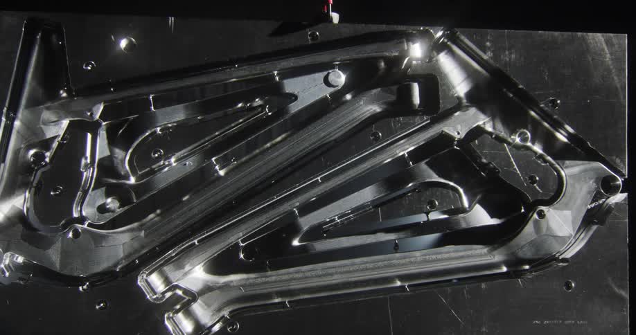 slow zoom-in on a CNC machined bike frame with light reflects pouring through
