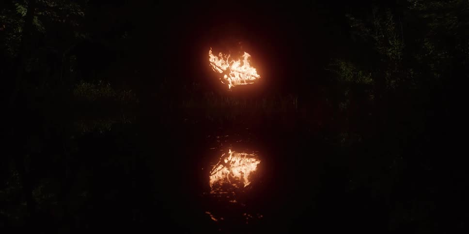 Bicycle frame in flame over a pound lake