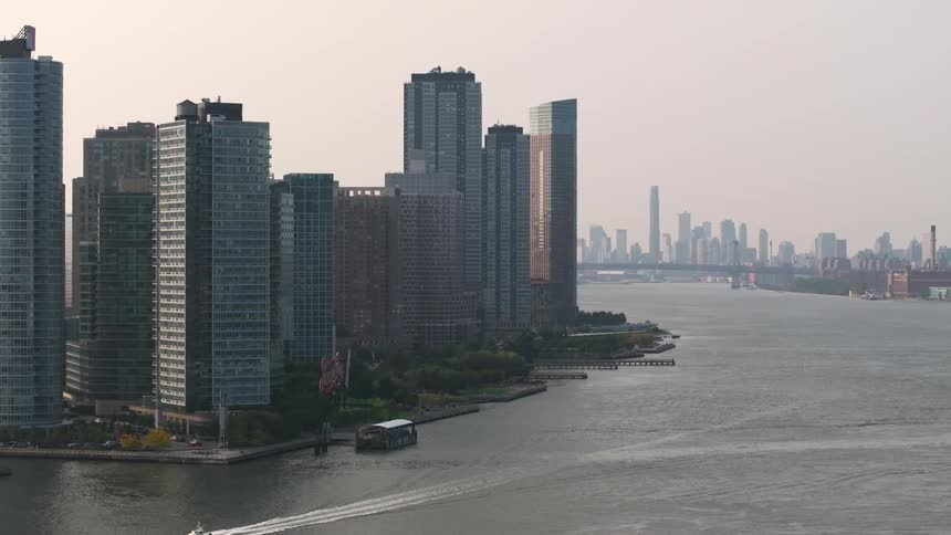 A boat travels past the city