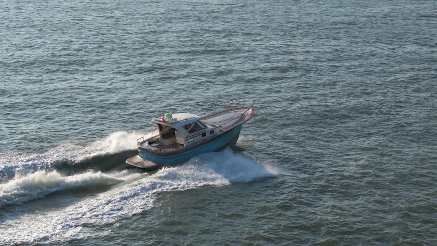 Aerial view of a boat moving through the sea
