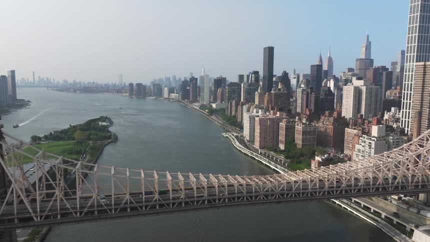 Aerial view of a bridge above the sea and connecting a metropolis