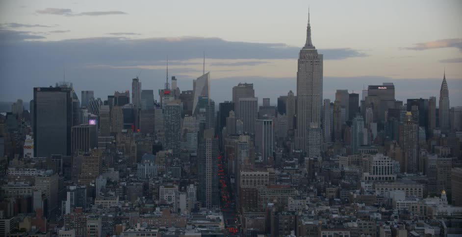 The sun is setting behind this large city