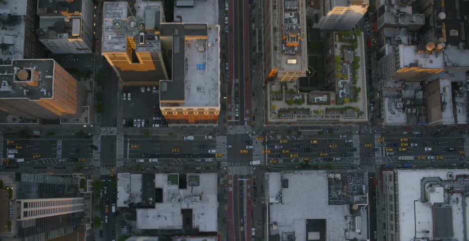 Traffic moves down city streets during the day