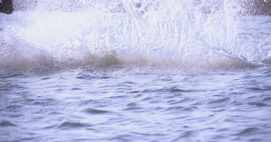 A man rides a board on a body of water