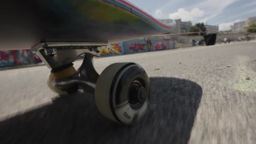 A skateboard wheel rolling down a street