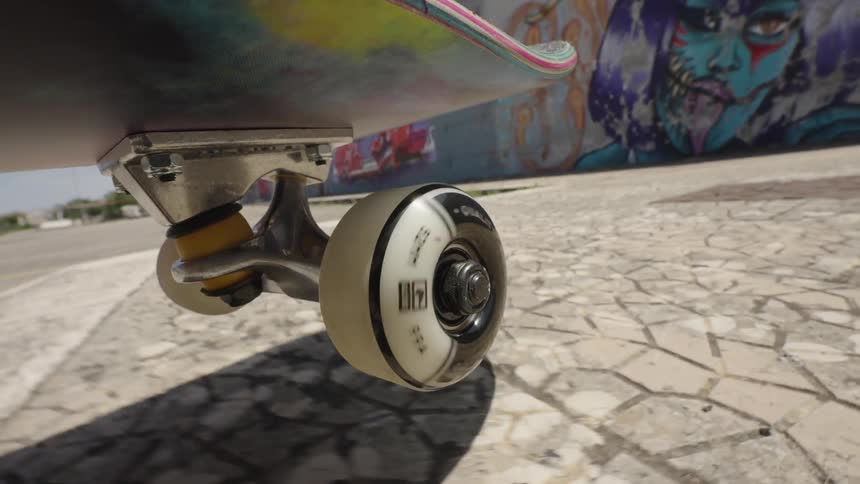 A skateboard jumping up onto a sidewalk