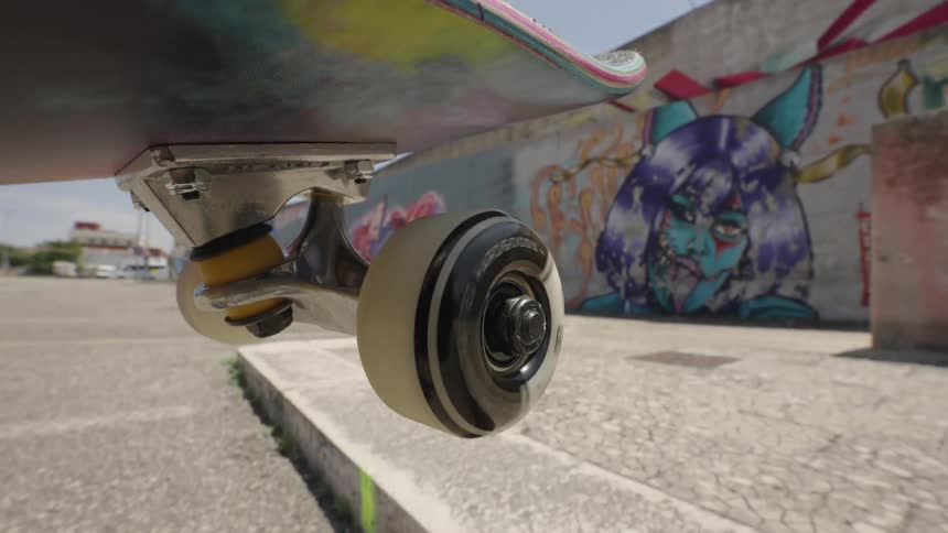 Point of view of a skateboarder doing a trick on a cobblestone street