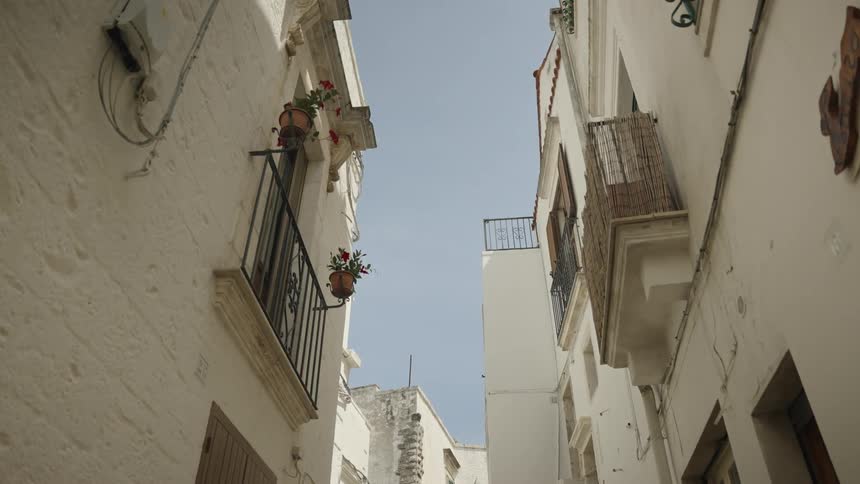 The alley runs past the apartment buildings