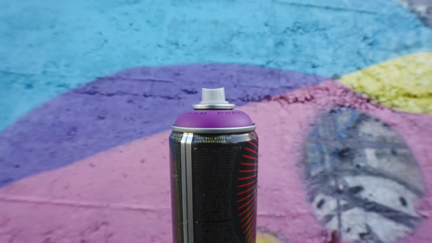 Point of view of a can of spray paint being applied to a wall