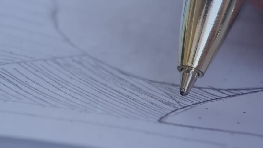 A pen drawing lines on a piece of paper