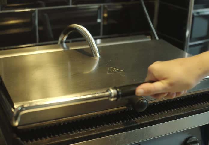 Bread being pressed in a restaurant