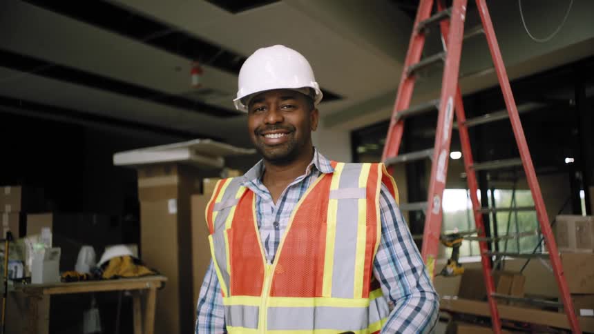 A worker is on site and smiling