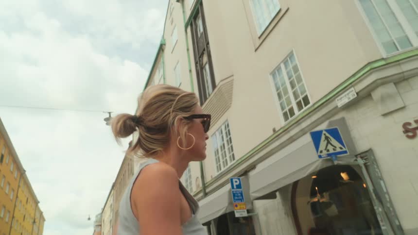 Blonde woman with sunglasses walking on the streets of a metropolis