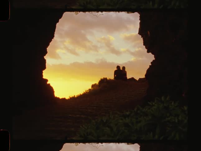 Couple cuddling while watching the sun set