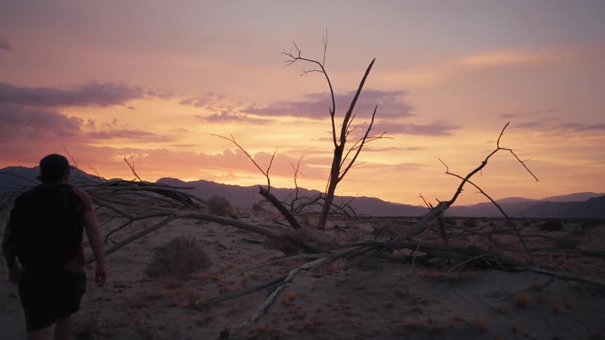 A man is hiking in the desert