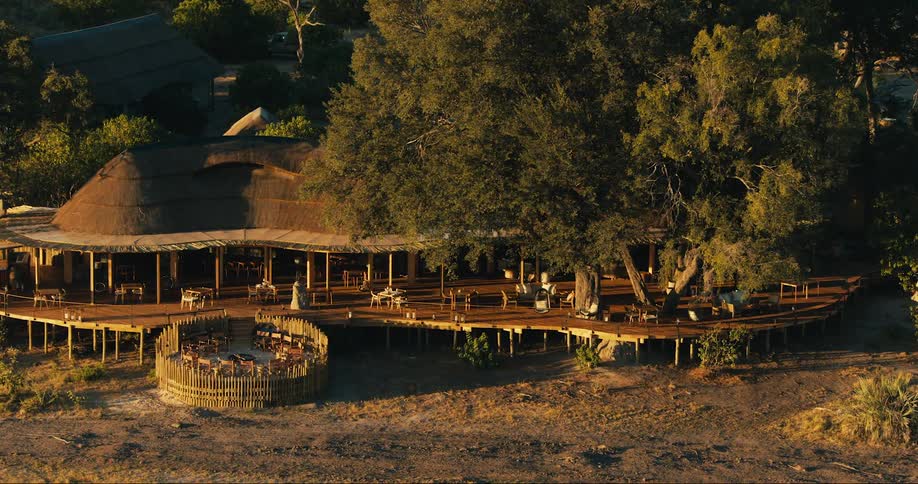 View of an African lodge with tables and chairs in a savanna setting