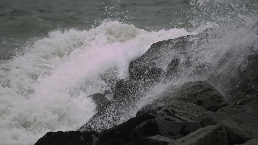 Waves crashing ashore in a rocky area