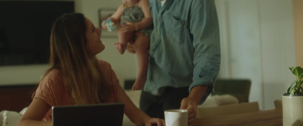 A man offers his wife a cup of coffee