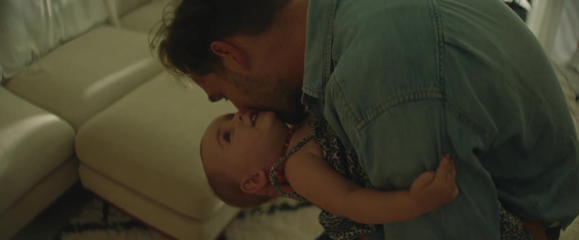 A father playing and pecking his daughter