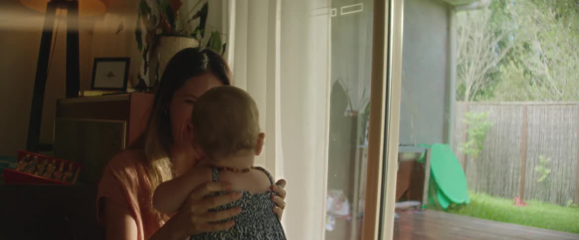 With fathers help daughter takes toddling steps to excited mother