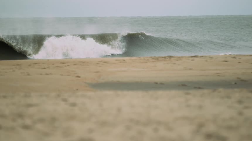 Extremely slow motion of small waves rolling ashore