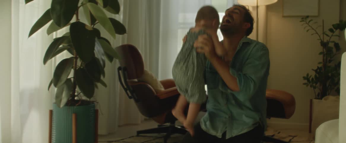 Daughter toddles from mother to father in home