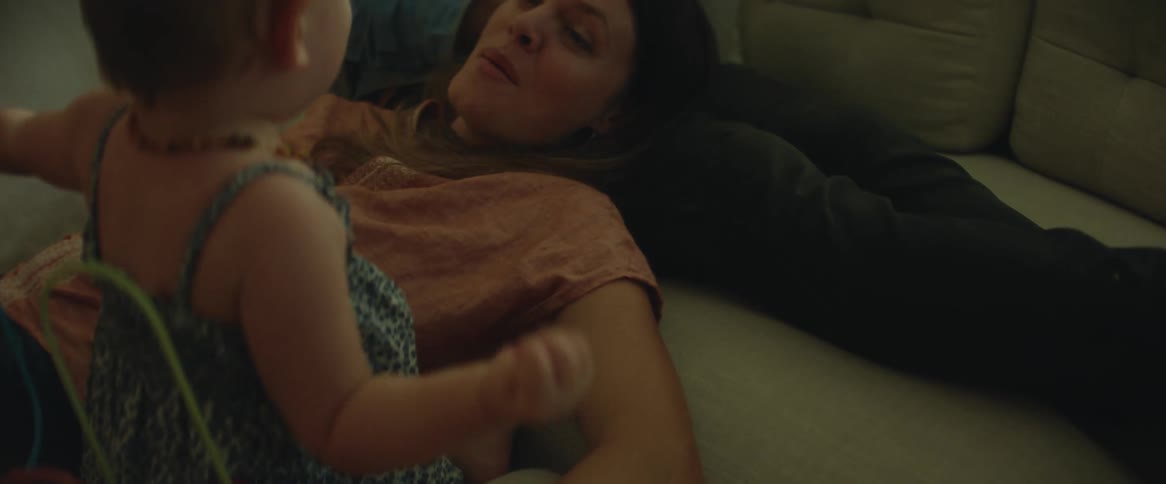 Mother and daughter are playing on the living room sofa
