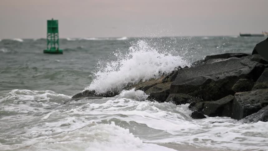 Water splashing up on the rocks at a beach