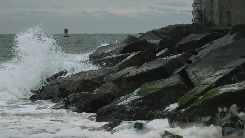 Ocean waves crash into a rocky shore