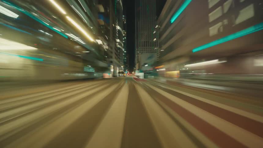 Buildings and street lights line a downtown street