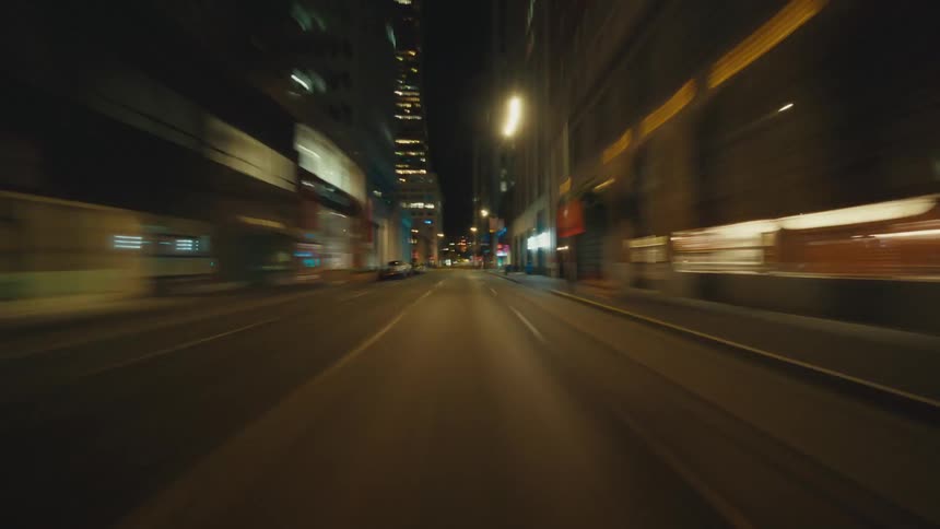 City lights illuminate the buildings and the streets at night