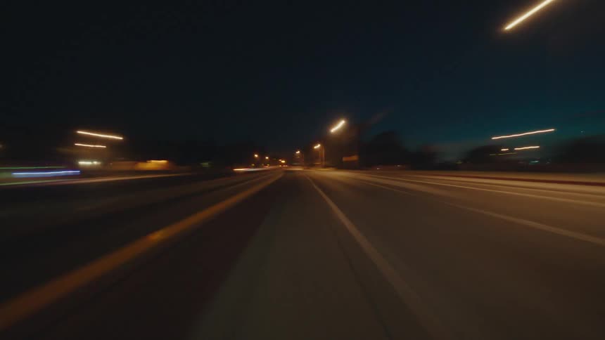 Moving view of a highway illuminated at night