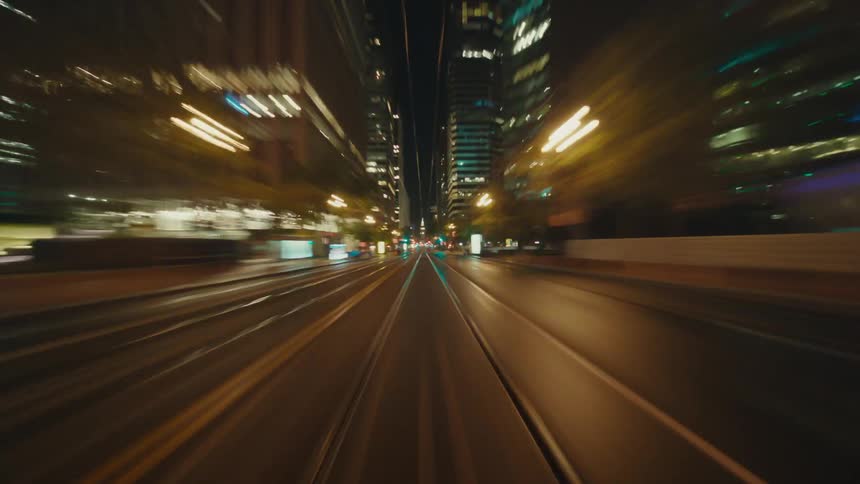 Building lights forms streaks during a rapid transit through the city at night
