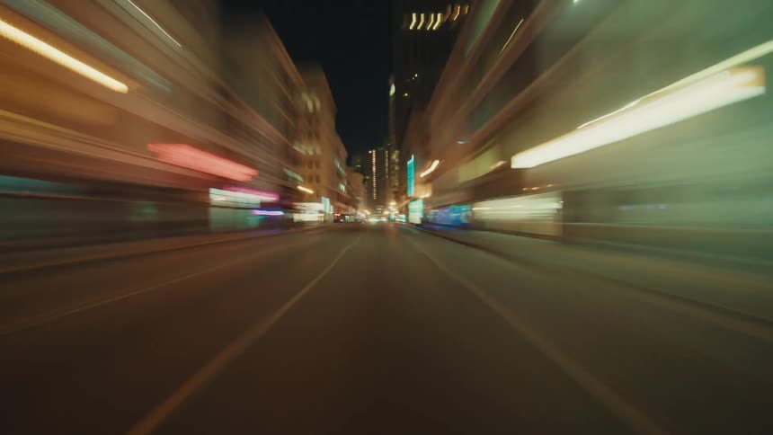 Streets and cars driving on them in a downtown city area