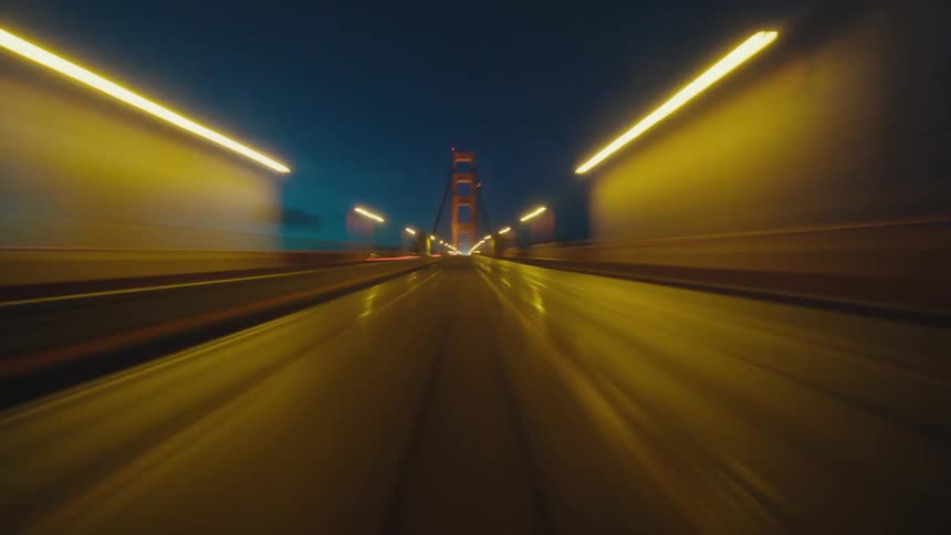 Timelapse pov footage of a vehicle driving over the Golden Gate Bridge at night