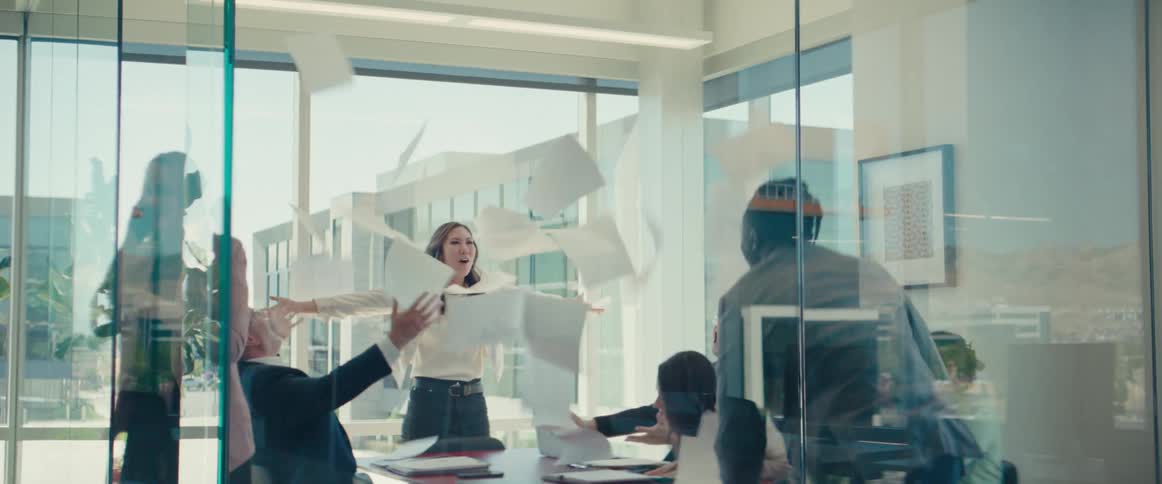 Group of people including men and women celebrating in an office meeting