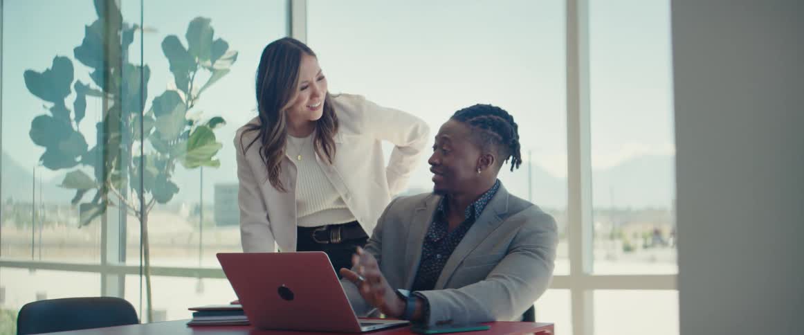 Man and a woman talking in an office room