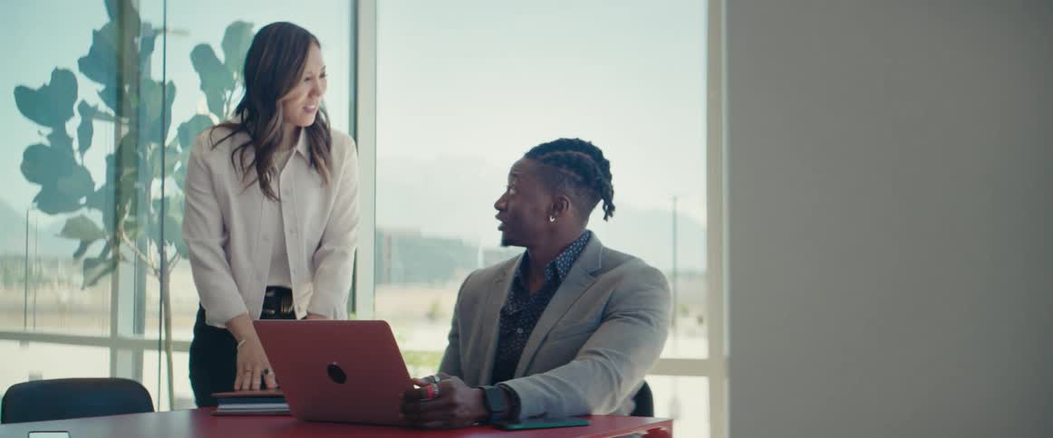 An asian woman and a black man collaborate in an office setting